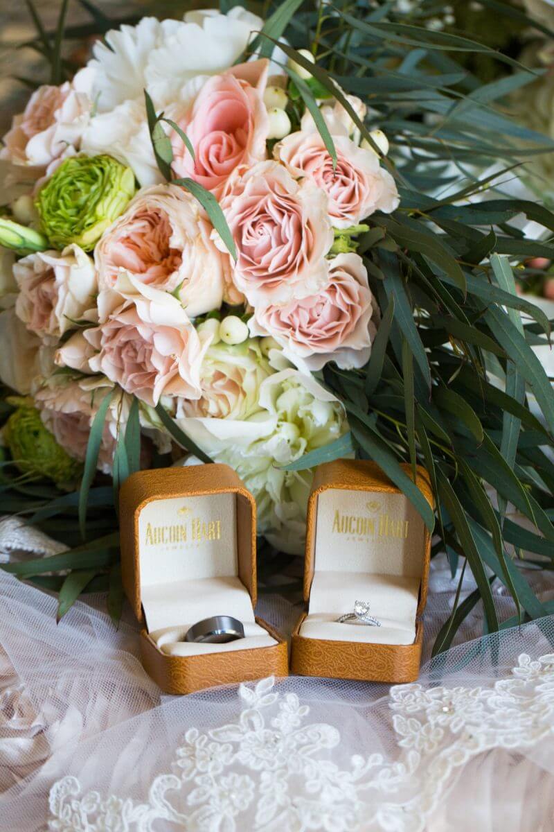 wedding rings in boxes posed in front of flower bouquet for ruston, louisiana wedding